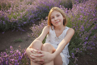 Portrait of a smiling woman standing on field