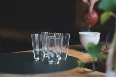 Cropped hand of woman pouring tea in cup