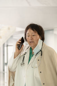 Mid adult man using mobile phone