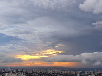 Scenic view of sea and buildings against sky during sunset