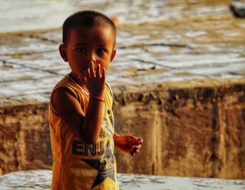 Portrait of boy standing in water