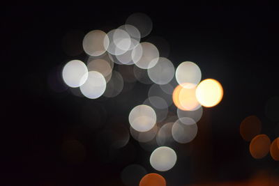 Defocused image of illuminated christmas lights at night