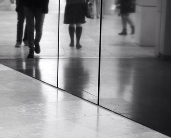 Low section of woman standing on tiled floor