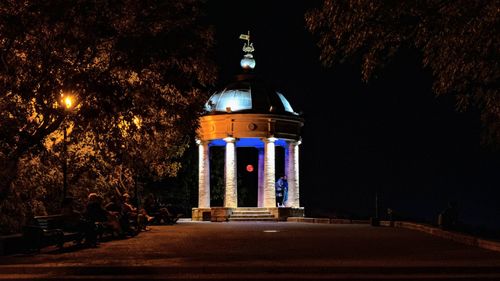 Illuminated building against sky at night