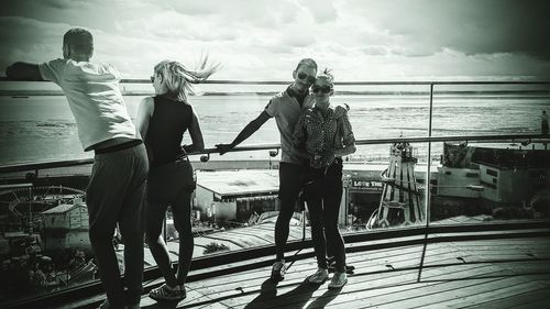 Rear view of woman standing by railing