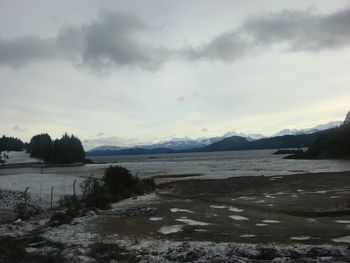 Scenic view of lake against sky during winter