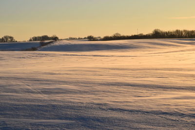 Scenic view of lake against sky during winter