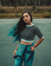 Portrait of a beautiful young woman standing outdoors