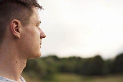 Close-up portrait of young man looking away