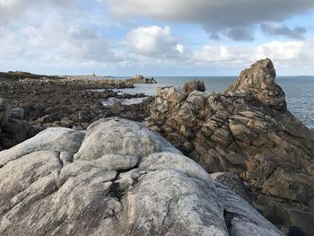 Close-up of sea shore against sky