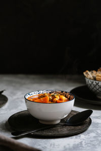 Vegan food, chickpeas stewed with tomatoes, zucchini carrots and peppers on bowl