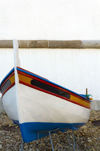 Boat moored on shore against lake