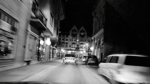 Cars on illuminated city at night