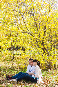 Woman sitting on plant during autumn