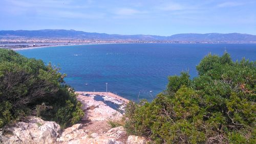 High angle view of sea and trees against sky