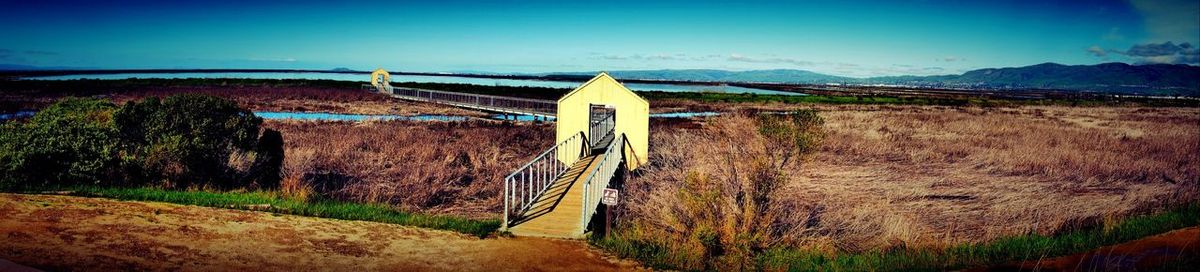 View of rural landscape against blue sky