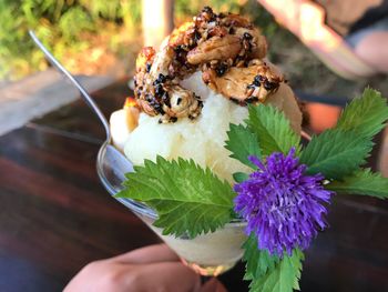 Cropped hand having dessert at table