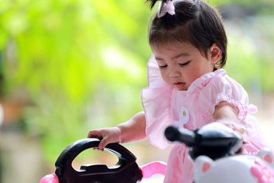 Face of a little girl riding a bicycle, portrait of an adorable little thai girl riding a bike