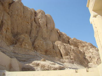 Low angle view of rock formations against sky