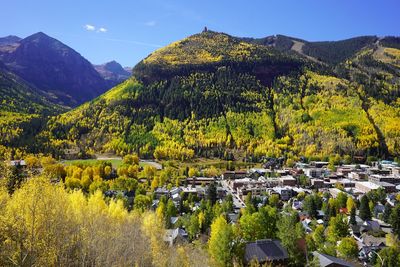 Scenic view of trees and mountains against sky