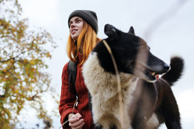 Low angle view of woman looking away during winter