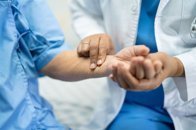 Midsection of man in hands
