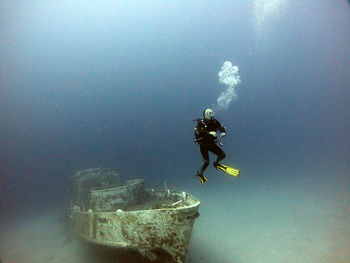 A diver dives next to the wreck.antalya kaş turkey