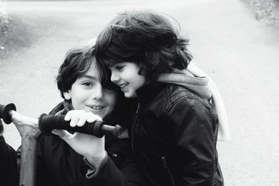 Smiling siblings on road