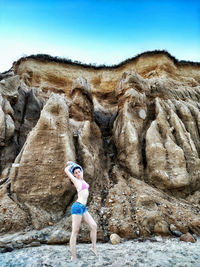 Woman standing on rock formation