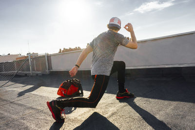 Man in cap training and stretching before competing.