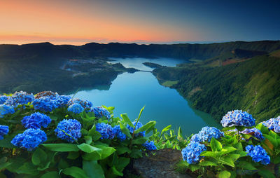 Scenic view of blue sea against sky during sunset