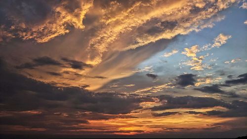 Low angle view of dramatic sky during sunset