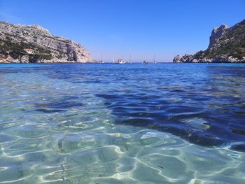 Scenic view of sea against clear blue sky