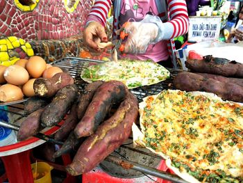 High angle view of people for sale at market stall