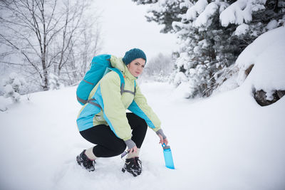 Full length of man skiing on snowy field