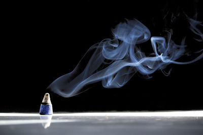 Close-up of cigarette against black background