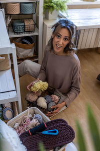 High angle view of young woman sitting on table