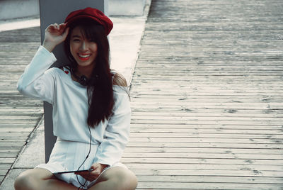 Portrait of smiling woman sitting outdoors