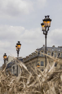 Low angle view of street light on field against sky