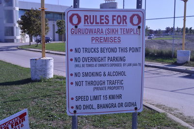 Close-up of sign board on grassy field