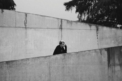 Portrait of boy relaxing on wall