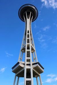 Low angle view of communications tower against blue sky