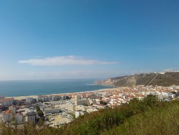 Aerial view of cityscape and sea against sky