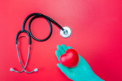 Close-up of human hand on red background