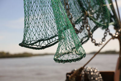 Close-up of fishing net hanging on rope