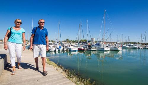 Panoramic view of people on beach against blue sky