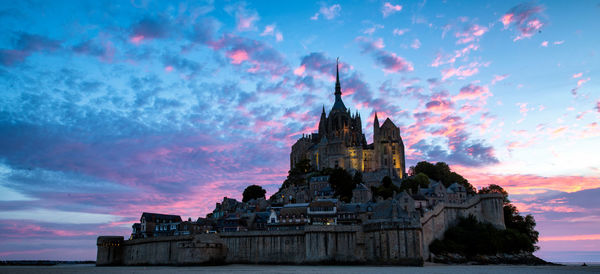 Low angle view of historical building against sky during sunset