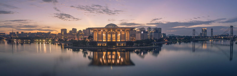 Reflection of buildings in lake at sunset