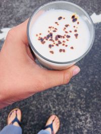 Low section of woman holding coffee cup