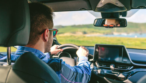 Portrait of man sitting in car